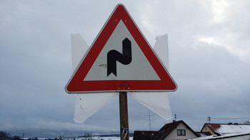 Traffic Sign with Angel Wings (front) / At first sight you cannot understand this photo. Why does this sign have &quot;angel wings&quot;? Looking at the back side of this traffic sign one can understand what happened. Check out the photo of the back side as well and you will understand!