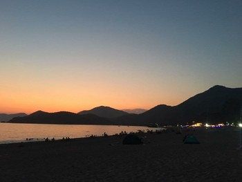 Great sunset and mountain view on the beach / Amazing sunset on the beach and people enjoying it