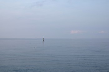 Calm sea in the evening with sailboat offshore / Calm sea in the evening with sailboat offshore