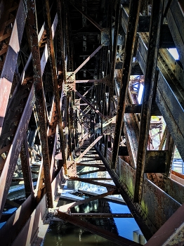 Rusty Bridge / A shot down the center of a triangular section of bridge support.