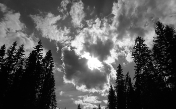 Apparation / Sunshine peeking past a belt of clouds