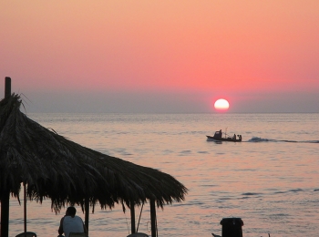 pink sunset at the beach / pink sunset at the beach under the fishermen's hut