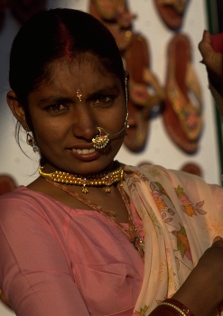 Facial Jewellery of Indian girl in Rajasthan / Of the many jewels an Indian woman displays around her body, the nose ornament (nath) is perhaps one of the most eye-catching.

The bindi, or forehead jewel, is placed on the area which is believed to house the agya chakra, or third eye. 

These examples of Indian facial jewellery complement the earrings and necklace beautifully.

https://travelnotes.org/pics/Asia/01-Rajasthan.htm