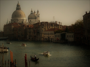 Classical Venice / The Grand Canal is the largest and most famous waterway in Venice. It serves as a vital transportation route, forming a major corridor for water traffic in the city. The canal stretches approximately 3.8 kilometers in length and varies in width from 30 to 90 meters.

The canal is lined with stunning architecture, including palaces, churches, and public buildings that showcase various styles such as Romanesque and Gothic.

Santa Maria della Salute, shown here, is a prominent Roman Catholic church and minor basilica located at the Punta della Dogana in the Dorsoduro sestiere of Venice. It is one of the most recognisable landmarks in Venice, famous for its striking dome that can be seen from various points throughout the city.

Photo by Michel Guntern, https://TravelNotes.org