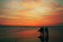 Surfers encounter sunset / boom imo