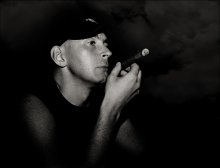 Pensive portrait with a cigar / ***