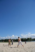 The boy in the white pants at the forefront among the playing frisbee on the Dnieper Beach / ***