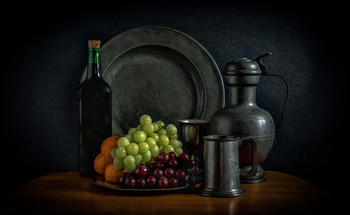 Fruit and wine / Still life with some fruit and wine along with pewter plates, jug and cups.
