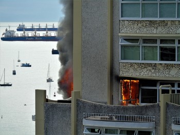 Apartment Fire / Vancouver BC Canada, apartment overlooking English Bay, cooking near the patio window shatters the glass and ignites the curtains causing the occupants to flea as the fire spreads.