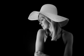 Millie in profile / Profile shot of Millie modeling a large brimmed white hat.