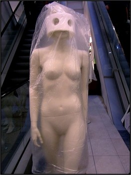 my alien darling / mannequin wrapped for delivery - artificial light in shop