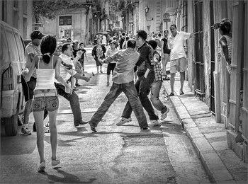Dispute on the road / I saw this scene during a visit to Havana / Cuba. A dispute between two men. One man was very irritable and threatened the other man with a hammer. Fortunately, the dispute is not escalated because people have separated the combatants on the road.
