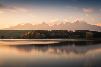 Autumn lake / Sunset at the small lake (pond) in Slovakia with High Tatras in the background.