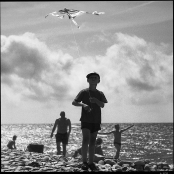 As a little boy enjoys the launch of a volatile snake.