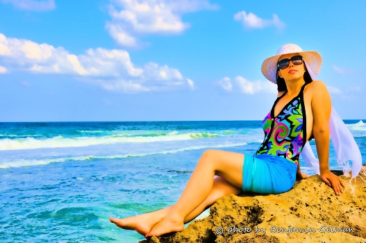 Girl on rocks by the sea
